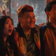 Awkwafina's Katy and Simu Liu's Shaun/Shang-Chi look at something in shock as Jon Jon (Ronny Chieng) smiles with his arms around their shoulders
